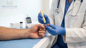 Doctor performing a finger-prick biomarker test during a metabolic health appointment.